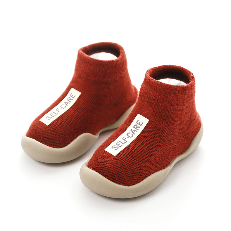 Stylish knitted infant booties with anti-slip soles, providing comfort for growing toddlers.