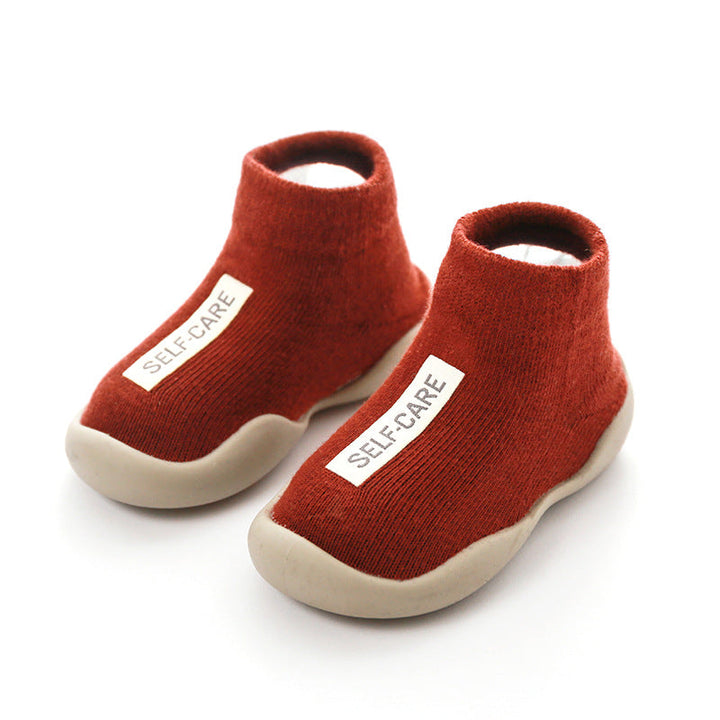Stylish knitted infant booties with anti-slip soles, providing comfort for growing toddlers.