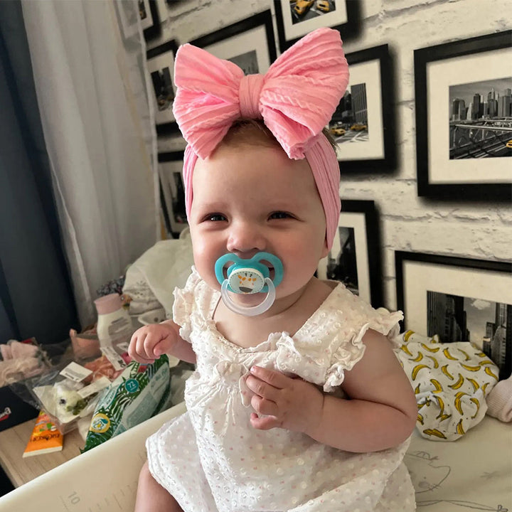 Soft nylon headband with stylish bow for infant girls, a comfortable baby hair accessory.