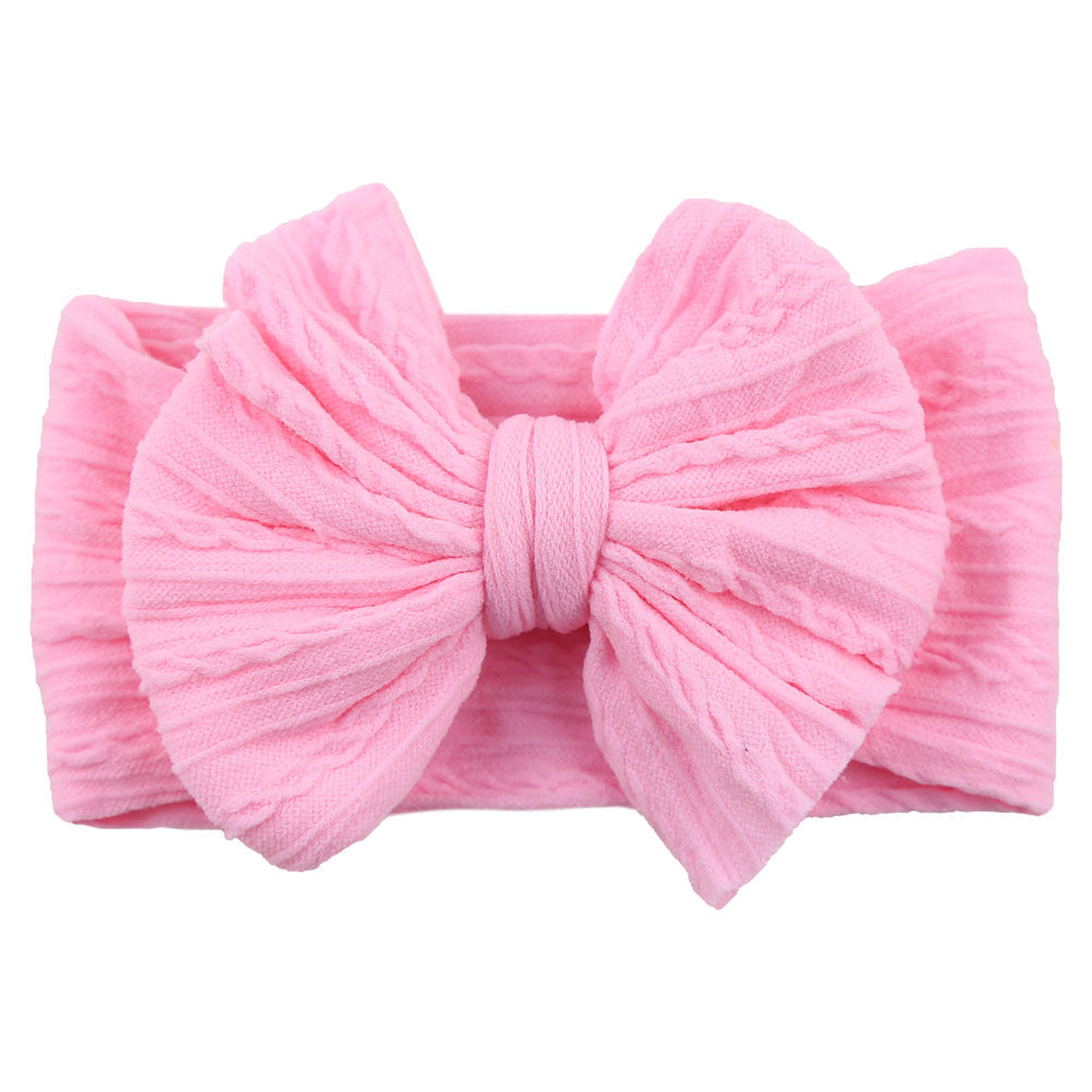 Toddler girl's comfortable stretchy nylon headband with a stylish bow.