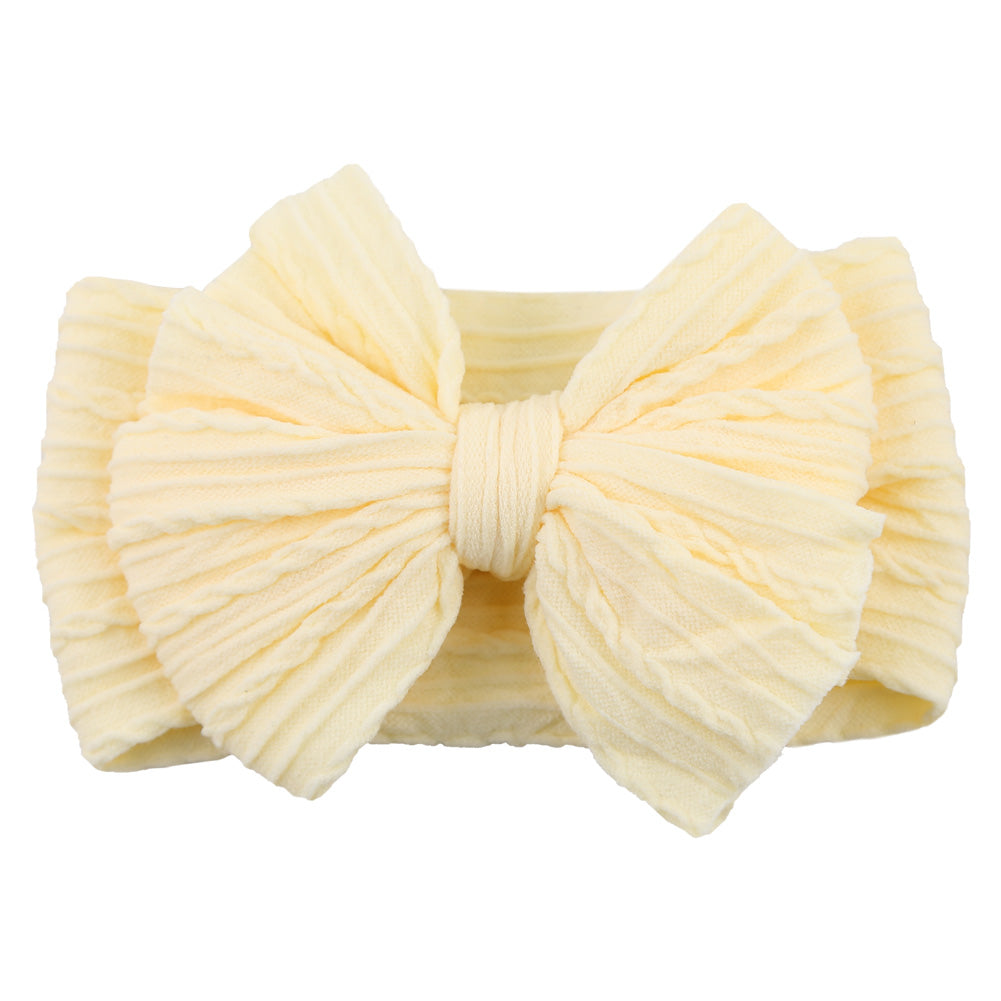 Colorful soft nylon headband with a stylish bow for infant girls, perfect for children's fashion.