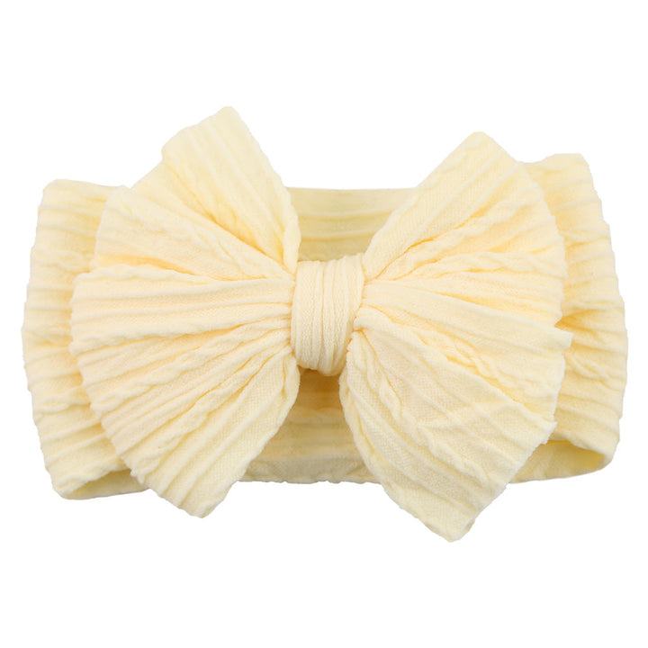 Colorful soft nylon headband with a stylish bow for infant girls, perfect for children's fashion.