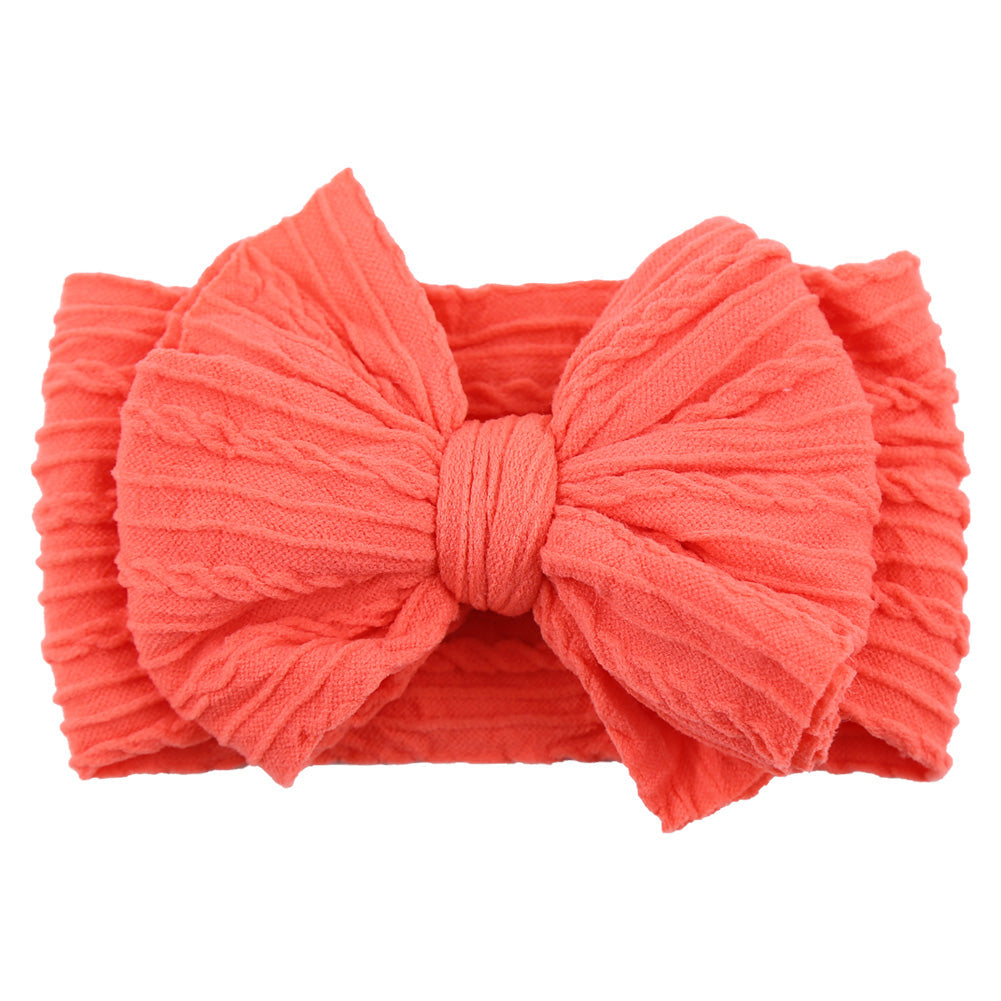 Children's soft nylon headband featuring a decorative bow; a perfect hair accessory.