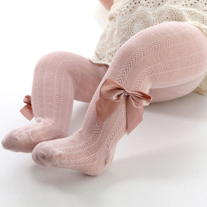 Soft pink baby girls' tights with a cute bow accent, perfect for spring & fall comfort. Infant toddler leggings.