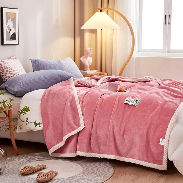 Soft pink flannel fleece blanket, ideal for cozy warmth in living room or bedroom. Plush, comfortable throw.