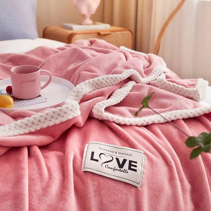Velvety soft pink flannel fleece blanket, a plush throw for cozy living room or bedroom comfort and warmth.