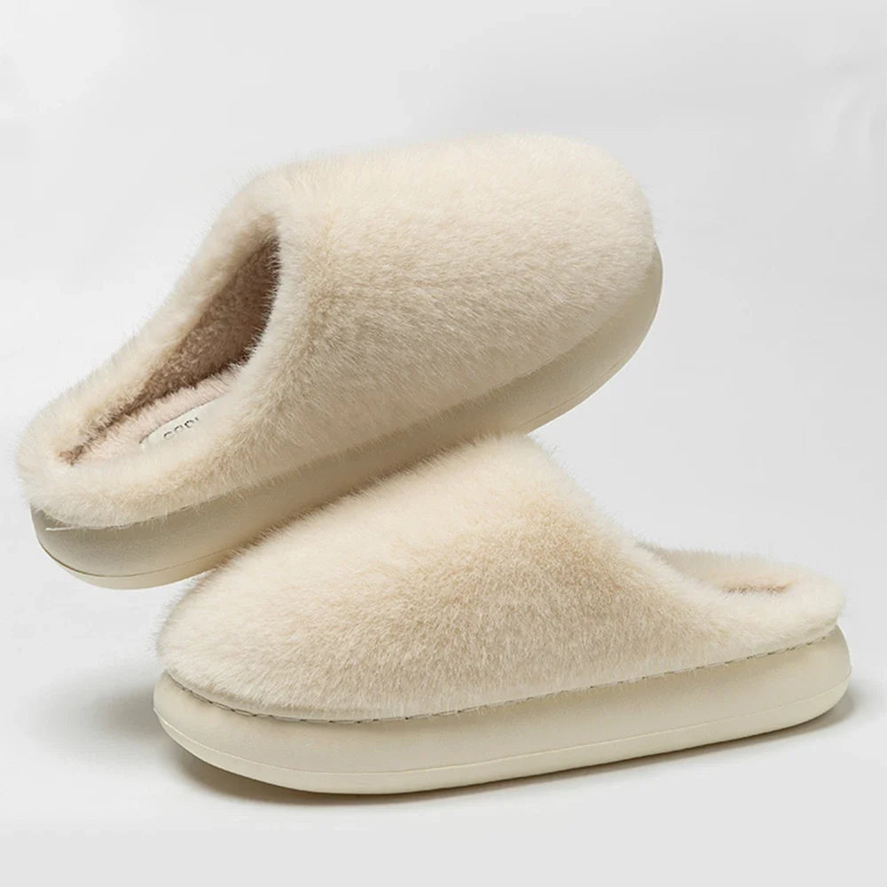 Woman's feet cozy in warm gray plush slippers, perfect indoor footwear for home comfort & relaxation.