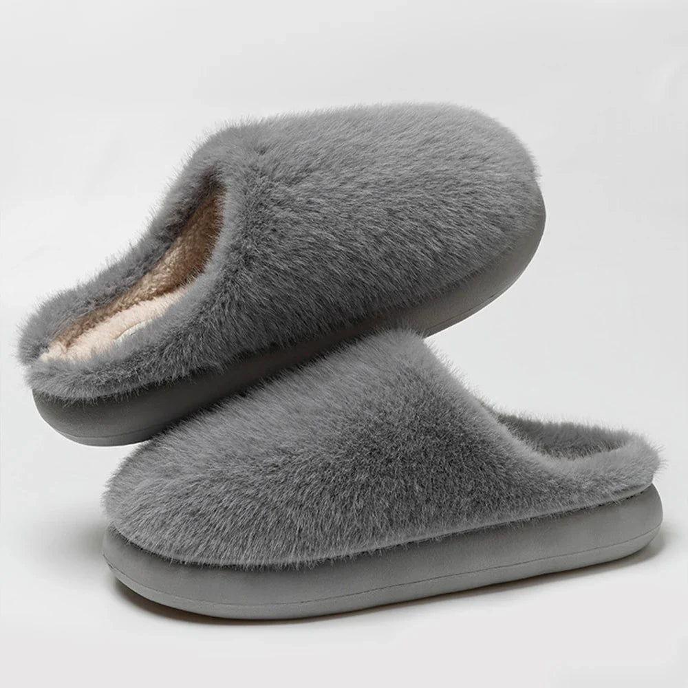 Durable sole on soft blue plush women's slippers, cozy indoor footwear for superior home comfort.