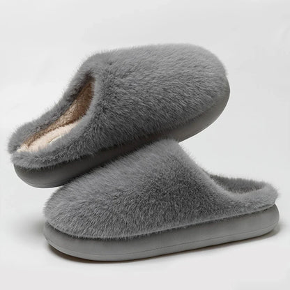 Durable sole on soft blue plush women's slippers, cozy indoor footwear for superior home comfort.