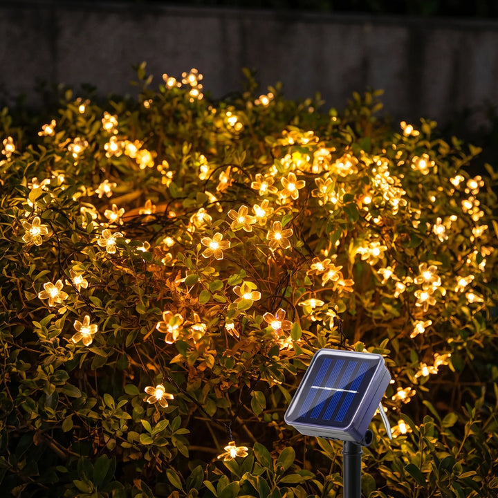 Solar LED flower string lights for enchanting garden decor, perfect for outdoor ambiance.