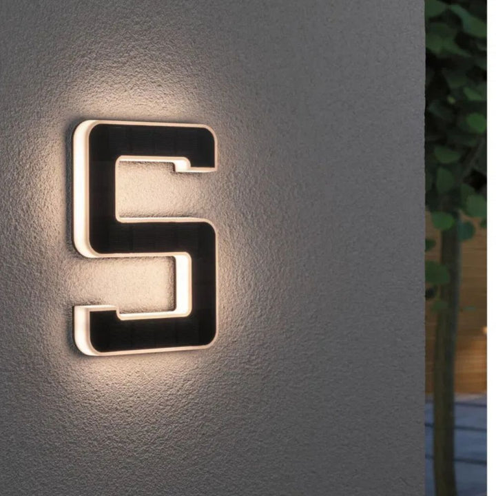 Sleek solar illuminated address sign, weatherproof for outdoor signage on any modern home.