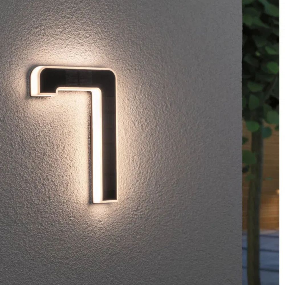Close-up of a solar powered illuminated house number, showcasing clear LED digits at dusk.