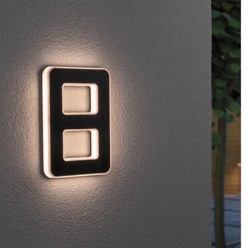 House with a glowing solar LED number, making the address visible from the street at night.