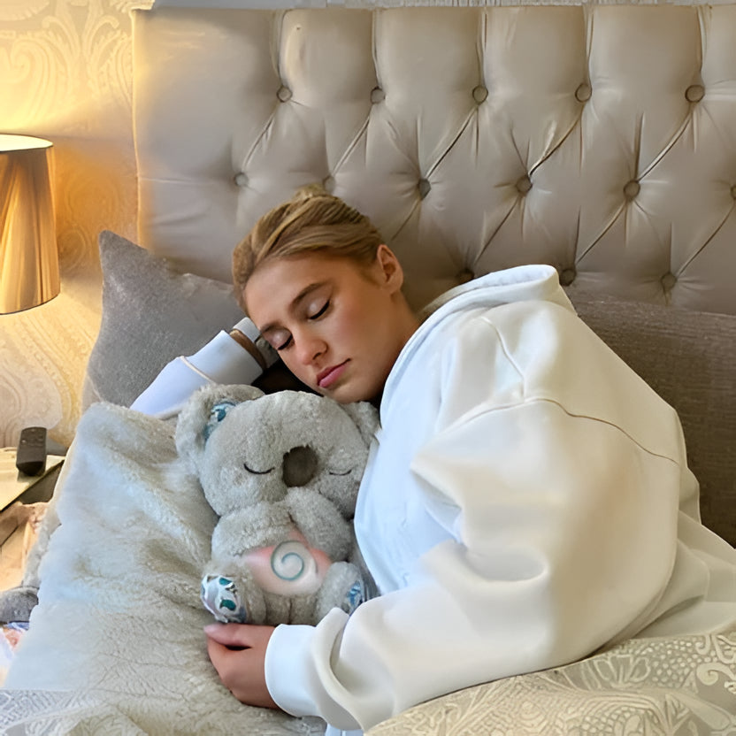 Soothing Koala plush for anxiety relief, soft grey, with calming music & rhythmic breathing.