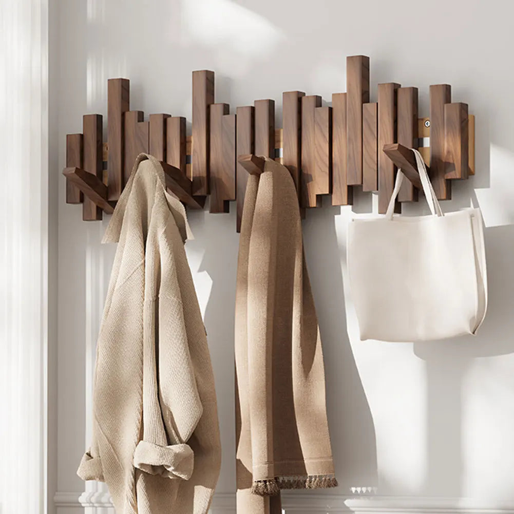 Space-saving wall mounted coat rack with foldable hooks, ideal for entryway organization and modern home decor.