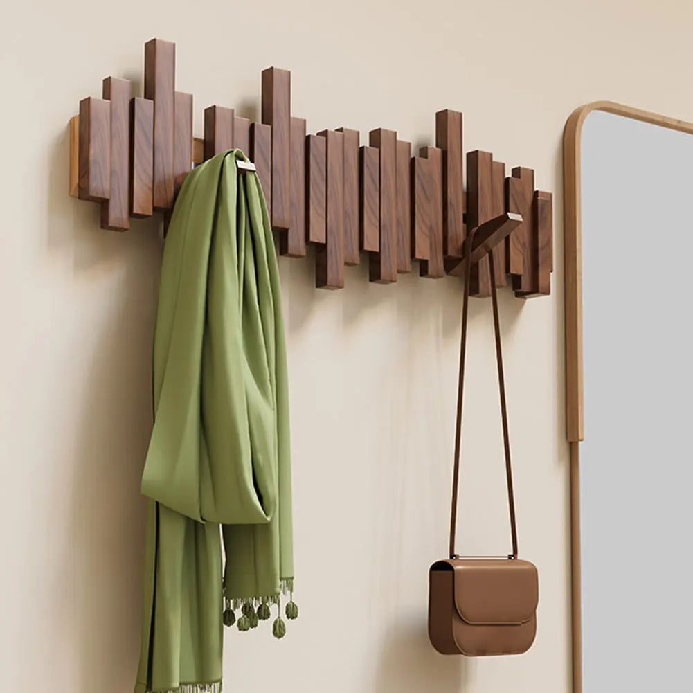 Natural wood wall hanger with foldable hooks. A modern, space-saving coat rack for organized entryways.