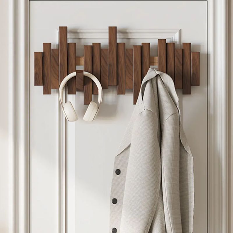 Smart space-saving wall mounted wood coat rack. Equipped with convenient foldable hooks, ideal utility hanger.