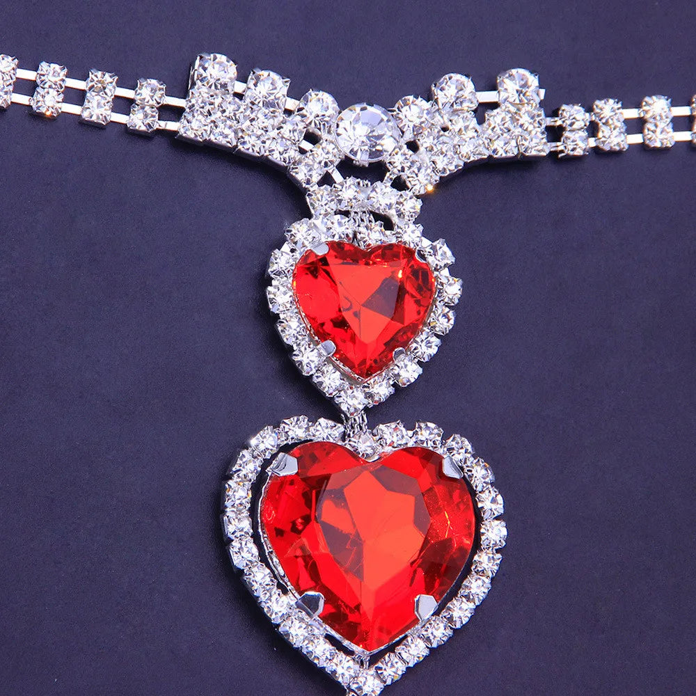 Intricate red heart rhinestone body chain, stunning women's jewelry accessory for special occasions.