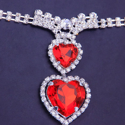 Intricate red heart rhinestone body chain, stunning women's jewelry accessory for special occasions.