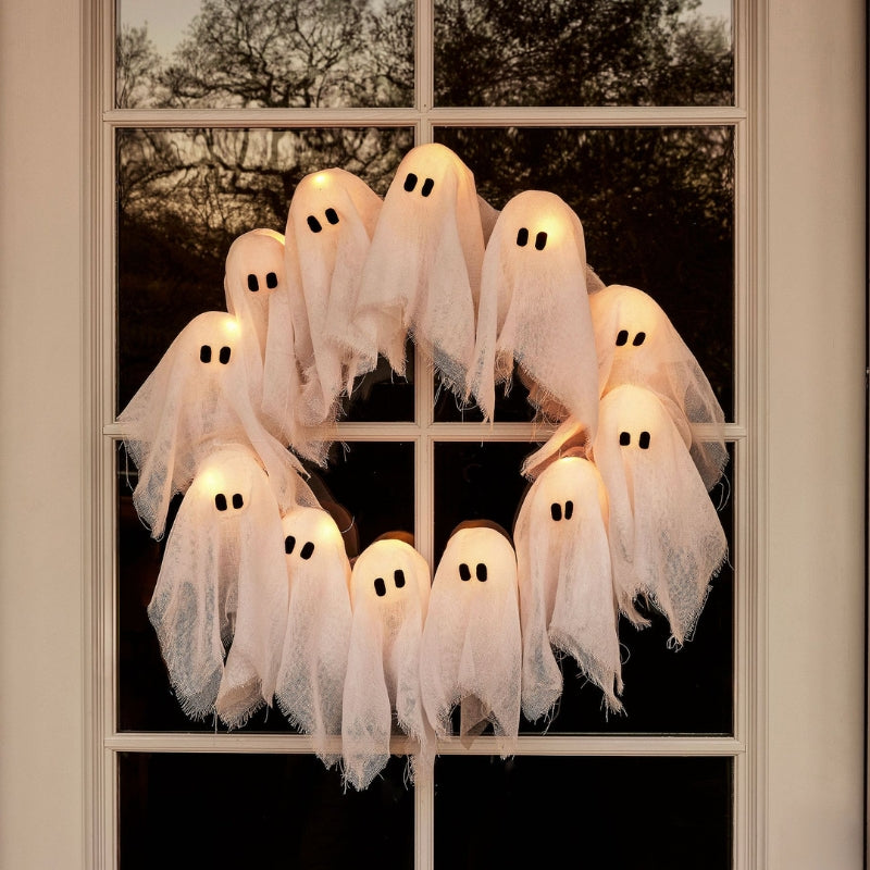 Spooky glowing ghost Halloween wreath with LED lights for festive haunted decor.