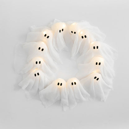 Haunted Halloween wreath featuring multiple white glowing ghost figures with bright LED lights.