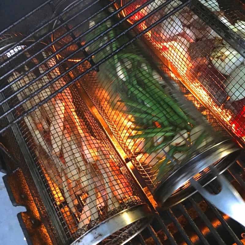 Durable stainless steel rolling grill basket, a must-have BBQ accessory for outdoor cooking enthusiasts.