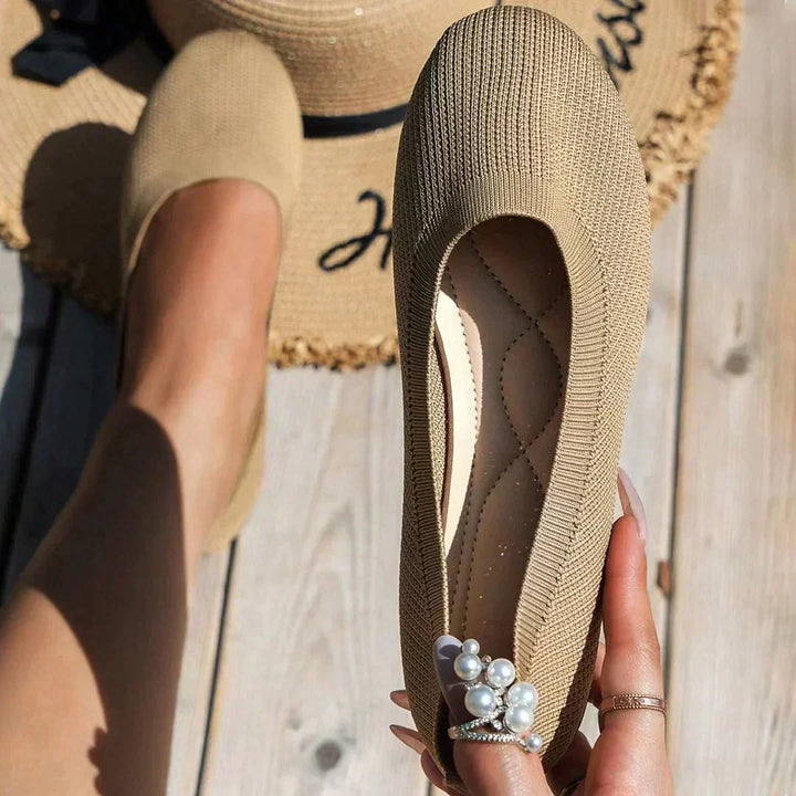 Top view of classic women's black orthopedic ballerinas, stylish comfort flats for everyday.