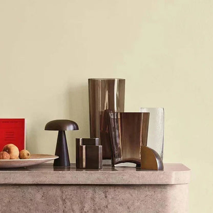 Stylish bronze ShroomLite LED desk lamp. Portable, wireless, and rechargeable for contemporary spaces.