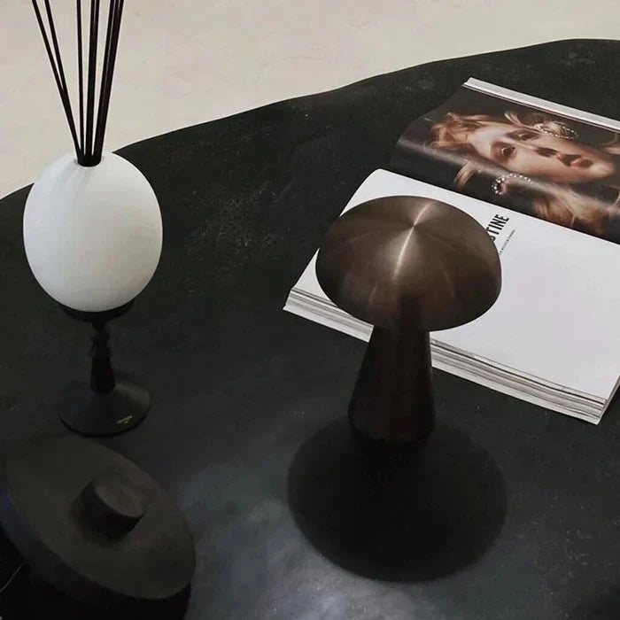 Elegant bronze portable LED lamp, mushroom design. Wireless & rechargeable for home and desk lighting.