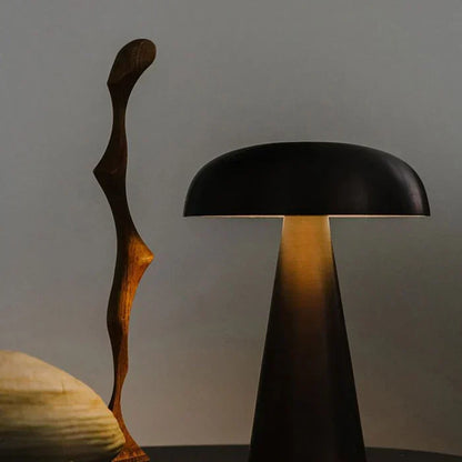 Sleek bronze finish portable LED table lamp, ShroomLite. Wireless, rechargeable light for modern spaces.