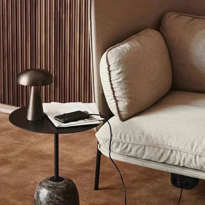 Modern gold portable LED mushroom lamp, ambient lighting. Rechargeable wireless light for stylish decor.