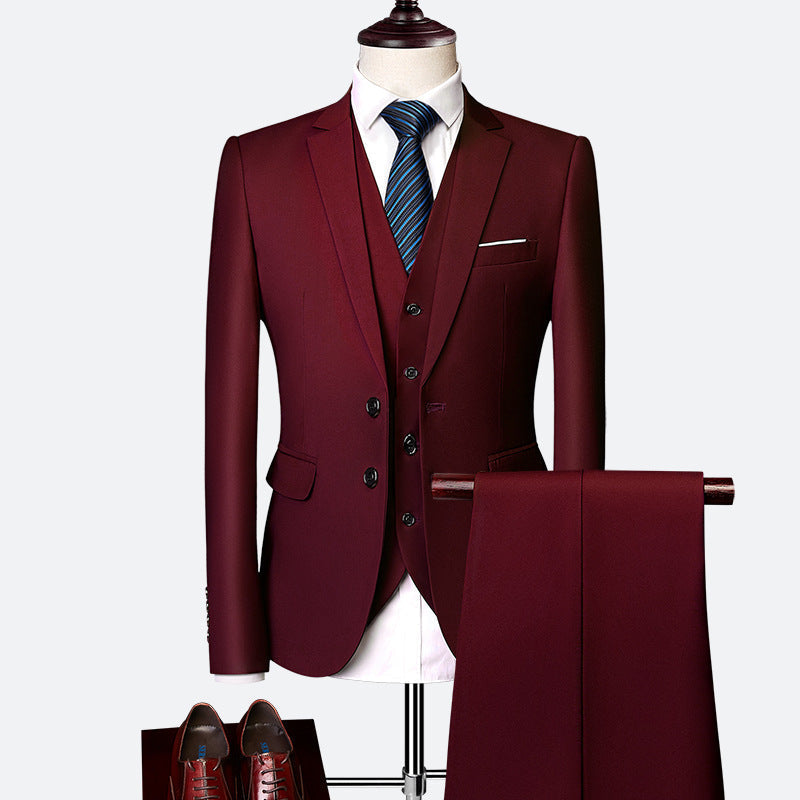 Modern men's tailored three-piece suit with a crisp white shirt, perfect formal wear for groomsmen or business meetings.