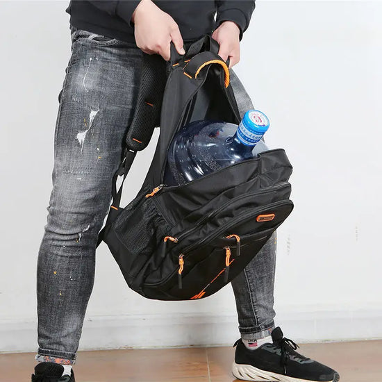 Front view: Black women's waterproof everyday backpack with multiple zip compartments for essentials.