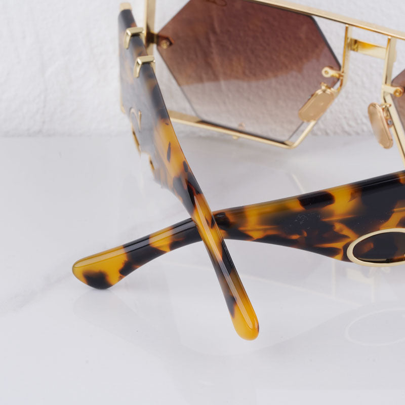 Fashionable gold green hexagon sunglasses with UV400 protection. Stylish alloy frames for unisex wear.