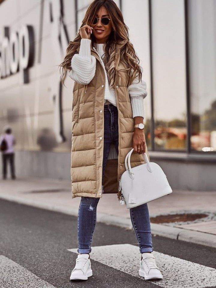 Elegant women's long quilted vest in black, offering a stylish silhouette and extra warmth for casual outfits.