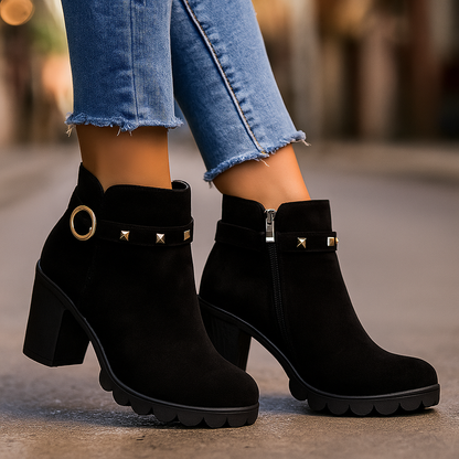 Chic women's black studded ankle boots featuring a sturdy block heel for stylish comfort and wear.