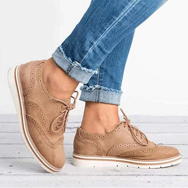 Comfortable women's oxford sneakers with classic brogue details & lace-up design for versatile fashion.