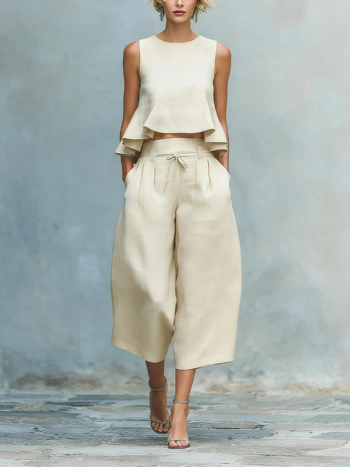Modern women's matching crop top & wide leg pants set. Stylish two-piece summer casual & travel outfit.