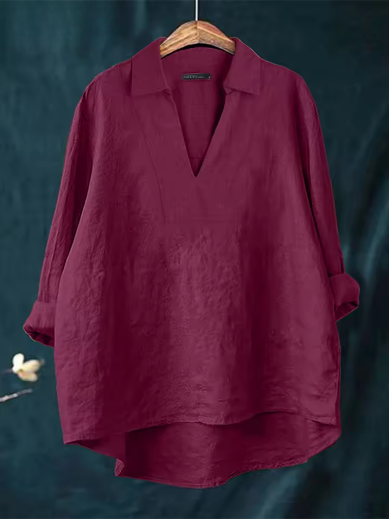 Woman wearing a stylish Nova V-neck blouse, a flowy top ideal for an elegant casual or comfortable business casual look.