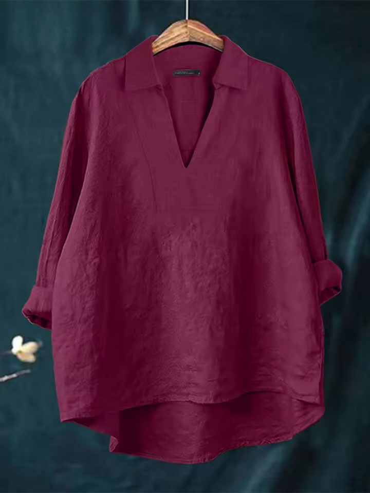 Woman wearing a stylish Nova V-neck blouse, a flowy top ideal for an elegant casual or comfortable business casual look.