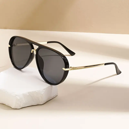 Women's oversized aviator sunglasses, UV400 protection eyewear with a sleek metal frame.