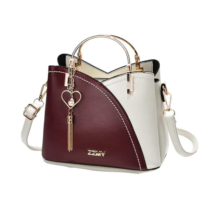 Unique women's patchwork shoulder bag with a decorative tassel. A fashionable and versatile accessory for any outfit.