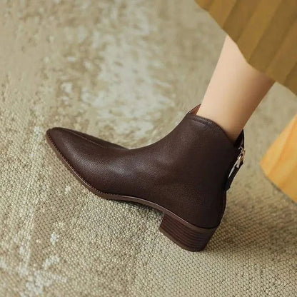 Black pointed toe ankle boots for women, featuring a stylish heel and convenient zip closure.
