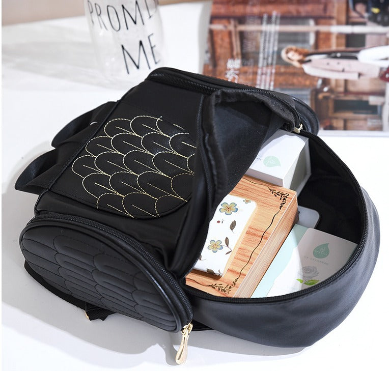 Side view of a casual PU leather owl print backpack for women, showcasing its spacious design.