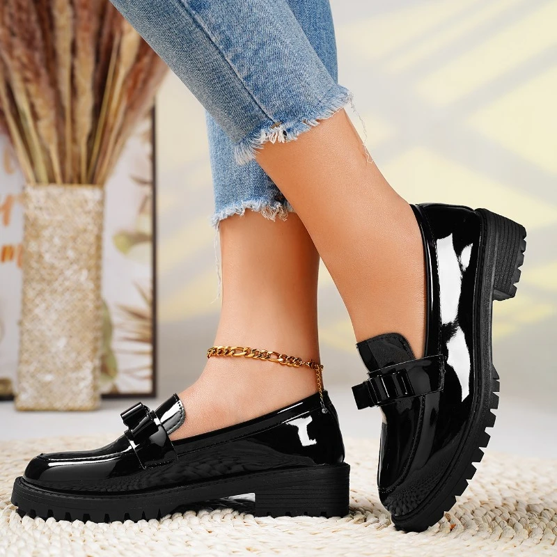 Fashionable women's loafers with a bold chunky sole and elegant bow detail. Easy slip-on style shoes.