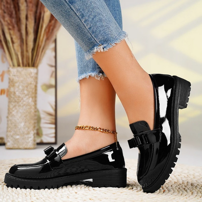 Fashionable women's loafers with a bold chunky sole and elegant bow detail. Easy slip-on style shoes.