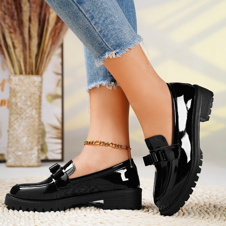 Fashionable women's loafers with a bold chunky sole and elegant bow detail. Easy slip-on style shoes.