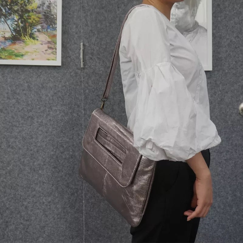 Elegant cream vegan leather women's shoulder bag, a minimalist and fashionable accessory for any outfit.