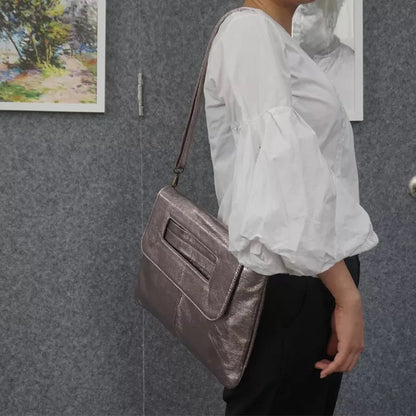 Elegant cream vegan leather women's shoulder bag, a minimalist and fashionable accessory for any outfit.