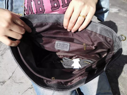 Rear view of the women's vegan leather shoulder bag, highlighting a convenient exterior zip pocket for easy access.